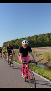 Joy biking in pink kit